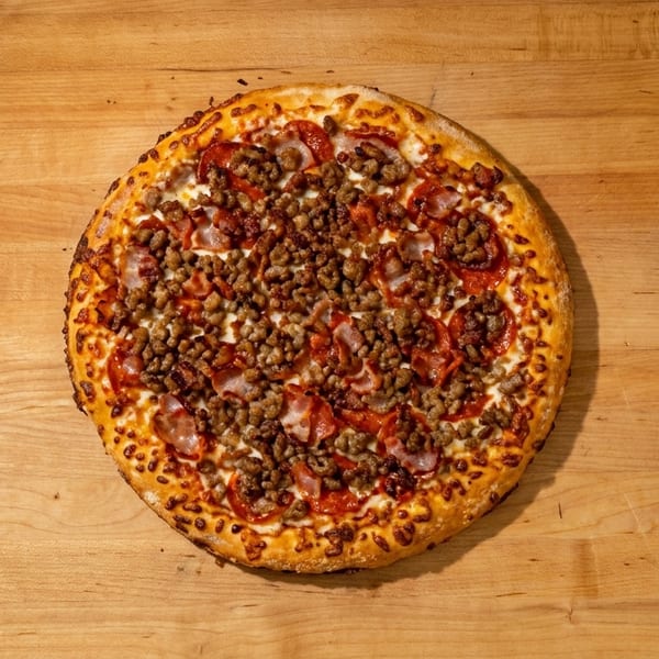 A whole meat lover's pizza with pepperoni, sausage, and bacon on a wooden table.